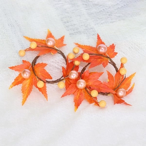 Detail of harvest maple leaf napkin rings with orange leaves and pearl accents