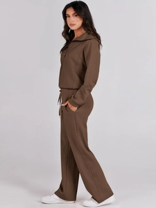 Detail view of brown long sleeve zip sweatshirt and wide-leg trousers tracksuit set