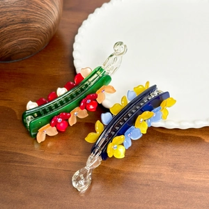Floral acetate hair clips with rhinestones in green and blue for elegant ponytails