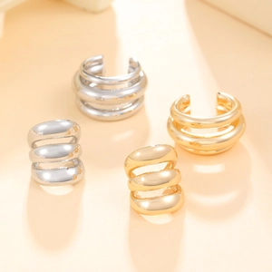 Minimalist multi-layered gold and silver ear cuffs featuring a sleek triple-band design