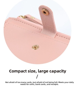 Detailed close-up of light pink leather wallet showing button closure and metal zipper