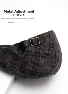 Close-up of wool plaid newsboy cap with adjustable gold buckle and leather strap