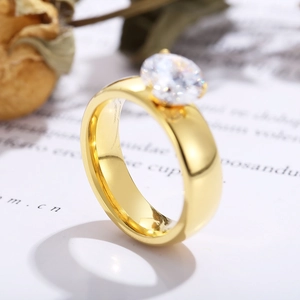 Elegant gold titanium steel ring with 6mm round zircon stone on a minimalist background