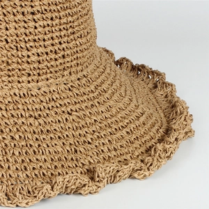 Summer straw sun hat with wavy brim and crochet texture in light camel for women beach vacations