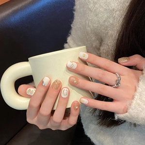 Handmade aurora floral press-on nails with pearls and gold foil in elegant creamy finish