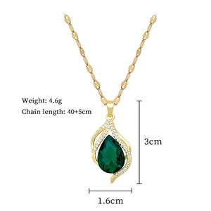 Detail view of gold necklace with green teardrop gem and precise size measurements