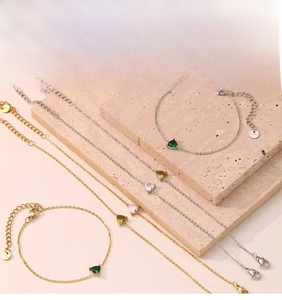 Detail of delicate link bracelets with triangular zircons and lobster clasp closure