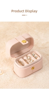 Macro view of compact pink PU leather jewelry box with velvet ring slots and earrings