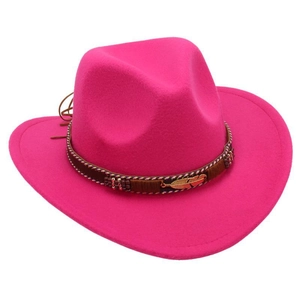 Detail of rose red cowboy hat featuring brown leather band and gold feather ornament