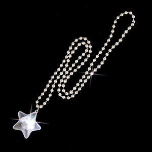 Close-up of a silver beaded star pendant necklace featuring professional sparkling light effects