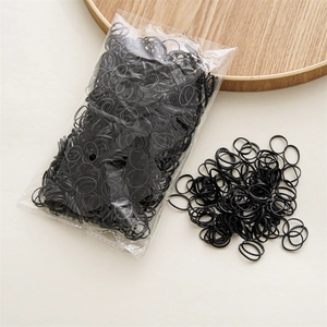 Detailed view of high-elastic black rubber hair bands in bulk packaging for girls