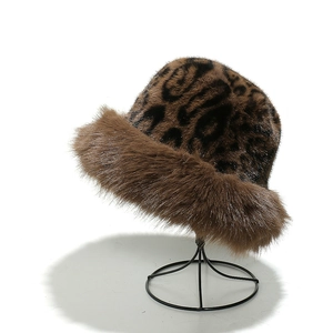 Winter fluffy leopard print faux fur bucket hat shown on a display stand for women