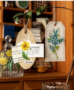 Macro shot of vintage plant stickers and bookmarks with floral illustrations on textured paper