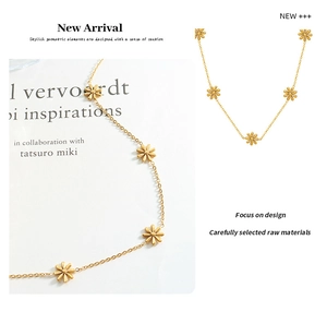 Detailed close-up of golden daisy flower necklace on artistic book background