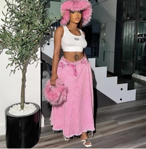 Pink faux fur bucket hat styled with a white halter top and a pink denim maxi skirt