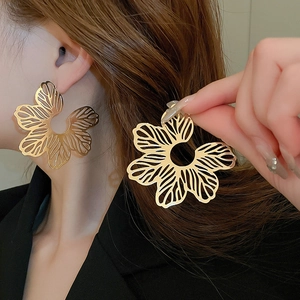 Statement oversized gold hollow flower stud earrings for women with intricate metal texture