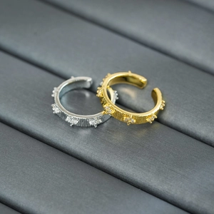 Macro detail of vintage gold brushed rings featuring sparkling star-set zircon accents