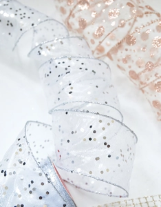 Close-up of sheer chiffon snowflake ribbon with silver sequins and metallic gold polka dots