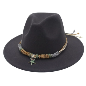 Dettaglio di cappello fedora nero con fascia intrecciata e ciondolo a stella marina