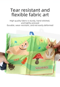 Detail of durable hand-stitched green baby cloth book with animal tails and forest patterns