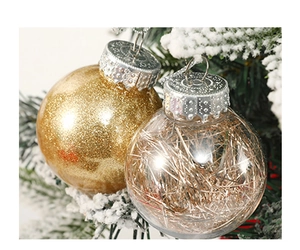 Close-up of golden glitter and clear plastic ornaments on a snowy Christmas tree branch