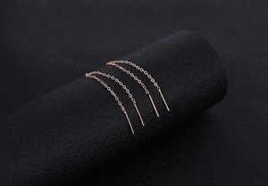 Detailed close-up of rose gold S925 silver long tassel earrings with sleek chain links