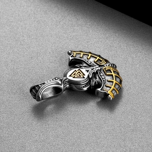 Close-up of silver and gold Viking Valknut axe pendant with Norse mythology details