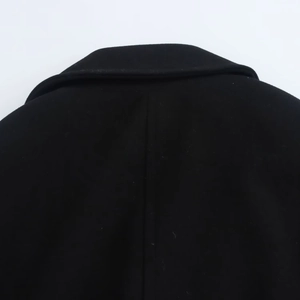 Close-up detail of the rear collar and shoulder stitching on a black wool coat