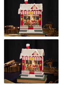 Close-up of Santa's Workshop snow globe featuring LED lights and hand-painted resin detail