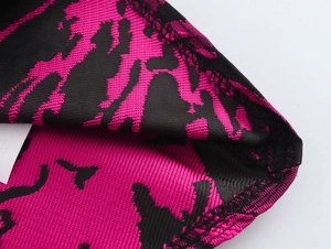 Close-up of sweet jacquard fabric texture on pink and black elegant dress