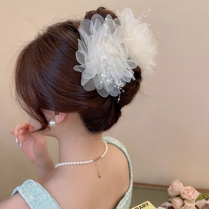 Detailed view of elegant white mesh flower hair clip with delicate bead decorations