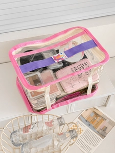 Transparent PVC cosmetic organizer bag with pink trim and purple handle for travel