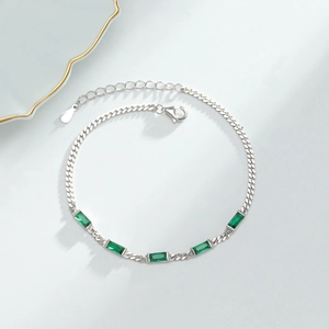 Detailed macro view of S925 silver bracelet featuring five green square-cut emerald stones