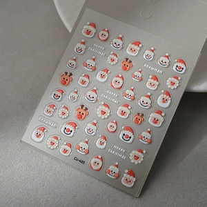 Macro view of 3D embossed Christmas nail stickers with Santa and reindeer motifs