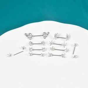 Various stainless steel nipple rings with flower, butterfly, and heart cubic zirconia designs