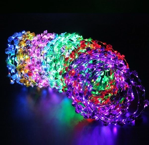 Detailed view of glowing LED flower garlands in blue, yellow, purple, and green colors