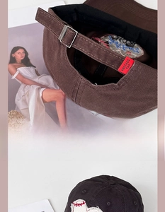 Detail view of a vintage dark brown cotton baseball cap with adjustable metal buckle strap