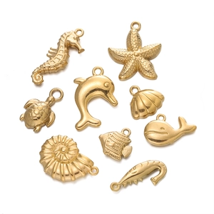 Set of 9 gold plated stainless steel sea animal charms including starfish and shells