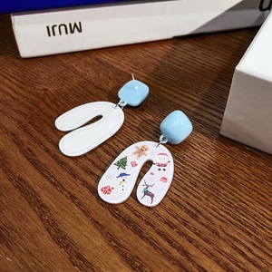 Asymmetric Christmas earrings featuring Santa and reindeer prints on white U-shaped pendants