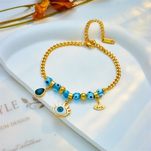 Golden stainless steel Cuban chain bracelet featuring blue Evil Eye beads and water drop pendant