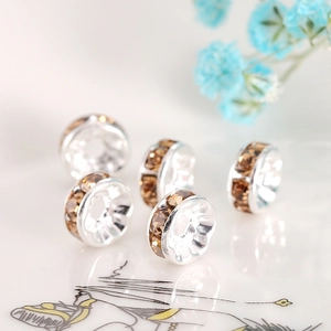 Macro detail of silver spacers with champagne crystals for DIY jewelry and bracelets