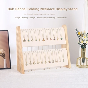 Detail of oak wood folding necklace rack with soft beige velvet display panel