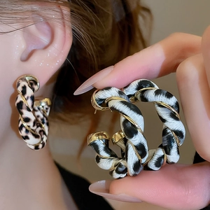 Fashionable hoop earrings with leopard print texture and twisted golden metal wire wrap