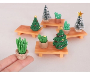 Miniature resin Christmas trees and cactus figurines on wooden stools for DIY decor