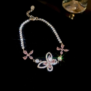 Macro detail of silver butterfly bracelet with pink zircons and sparkling stones