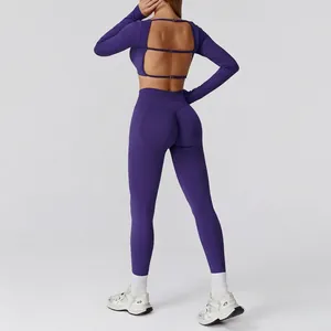 Women's seamless purple yoga set featuring open back long sleeve top and high waist leggings
