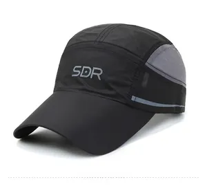 Detail of breathable grey mesh fabric and SDR logo on black quick-dry baseball cap