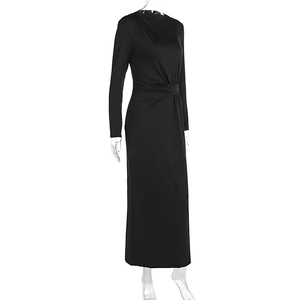 Detail of waist-crossing pleats on a black long-sleeved slim fit midi dress