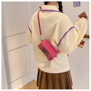 Pink retro telephone-shaped crossbody bag with soft chain strap and dial detail