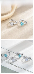 Detailed tile display of star-shaped zircon earrings in silver with blue and white stones